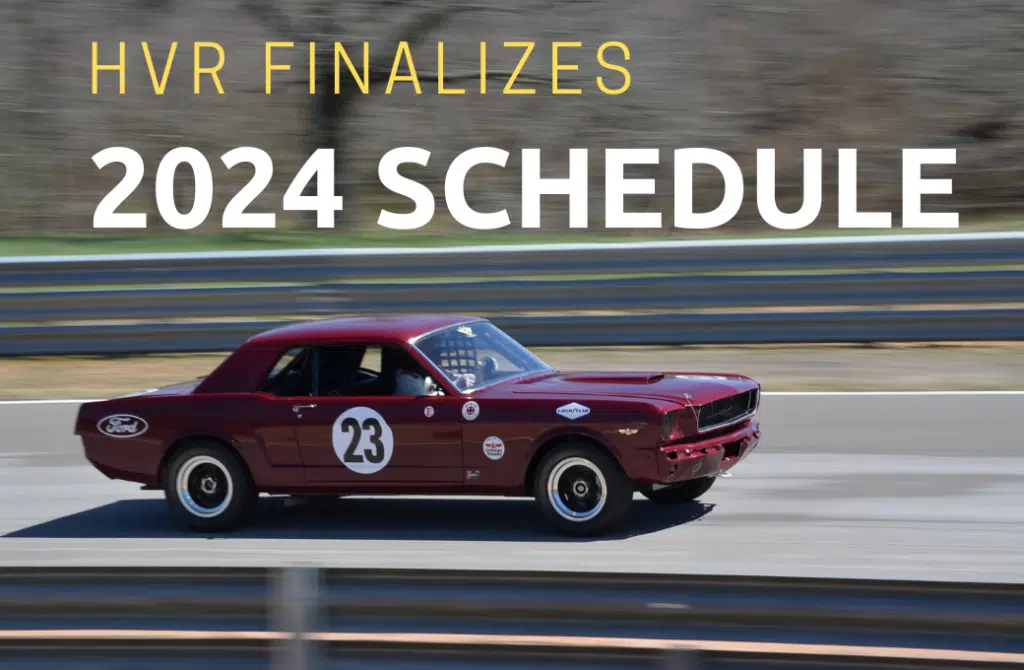 Vintage red Mustang on race track.