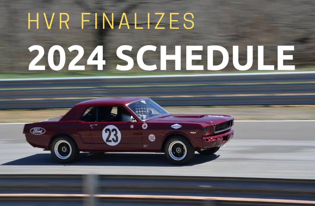 Vintage red Mustang on race track.